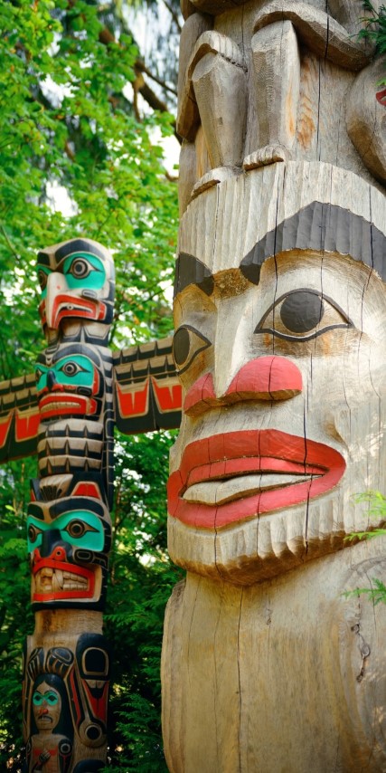 Indian totem, black red and green. human and animal form. raw wood
